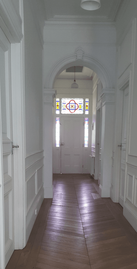 Skilled craftsmen repairing a plaster ceiling's cracks and imperfections